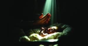 Family in prayer overcoming doubt and declaring Jesus healer during infant's healing miracle