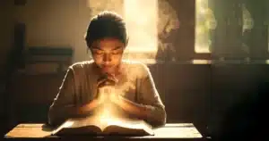 Miriam at desk experiencing hearing God as Bible words lift off the page in heavenly light